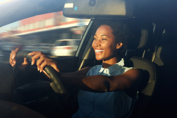 Image of a happy woman driving a car